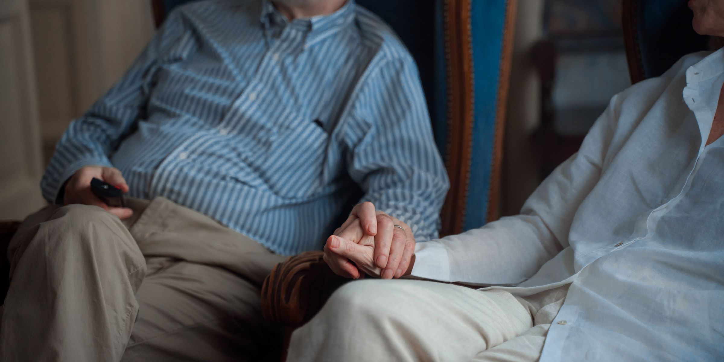 Elderly couple holding hands, symbolizing comfort and companionship